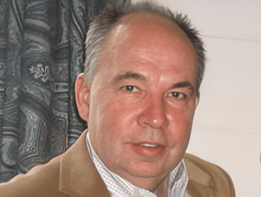 Middle-aged man smiling indoors